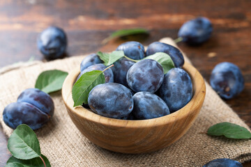 Sweet Plums in a plate  on a wooden  table.