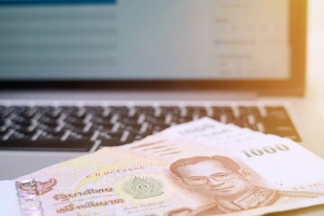 Banknotes lie on the keyboard of a laptop. The concept of making a profit from the Internet. Online Business concept.