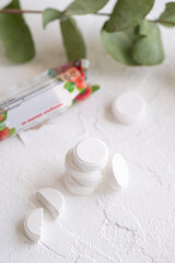 Vitamin C tablet on white background. White pills of ascorbic acid