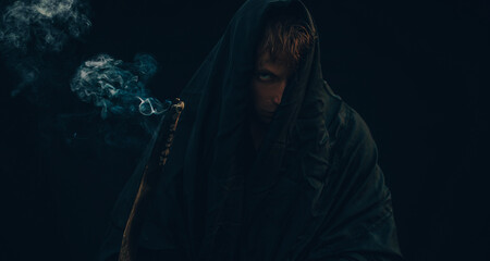 Warrior in smoke with ancestor's tale. 
Dark background. Halloween concept. Photo. 