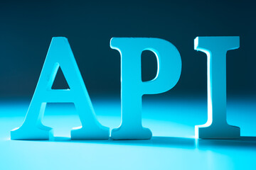 API. Three-dimensional letters API on a blue background. Application programming interface. Program interface for interacting with other programs. API technologies in programming.