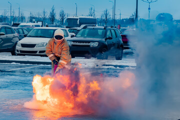 Fire fighting in the Parking lot. Firefighter eliminates ignition. Firefighting. Fire fighting. Emergency situation. Fire Department training. The job of a lifeguard. Extinguisher
