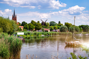 Colorful sailboat in front of a little river island, witch is part of the town Werder, Havel - obrazy, fototapety, plakaty