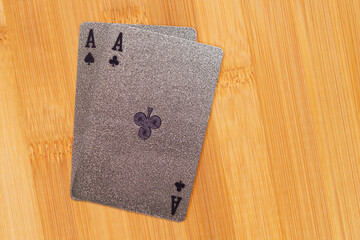 Silver embossed playing cards on the bamboo background.