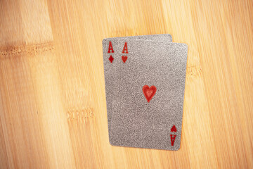 Silver embossed playing cards on the bamboo background.