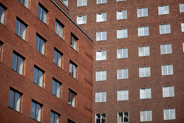Tall city buildings made of bricks and windows