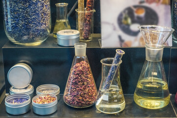 composition with perfume samples and dryed flowers in flask. alchemy and aromatherapy set with...