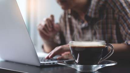 Casual business man online working on laptop computer in coffee shop