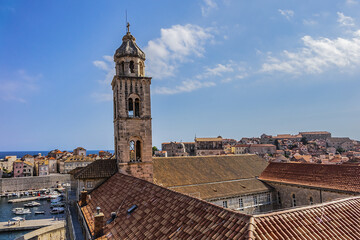 Fototapeta na wymiar Church tower of Dominican Monastery (Dubrovnik Dominikanski Samostan, 1225) and the orange-tiled roofs of old town. Dubrovnik, Mediterranean, Croatia.