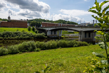 Fototapeta na wymiar city view with old buildings and green trees and a river