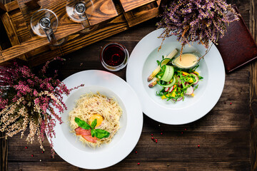 two course lunch - pasta with bacon and cheese and fresh salad with radishes and herbs
