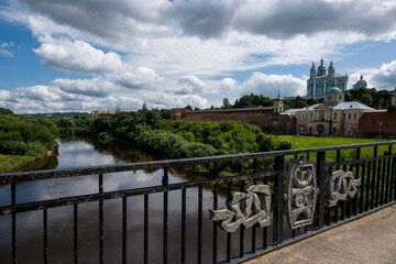 city view with old buildings and green trees and a river