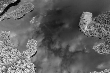 panoramic landscape of lake and forest around in summer at dawn filmed from a drone
