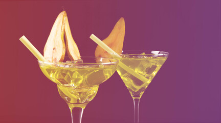 Green alcoholic drinks on the basis of pear with ice cubes prepared by the bartender