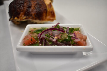 A Small Salad Plated Next to Rotisserie Chicken