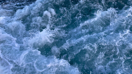 Naklejka na ściany i meble Seawater surface. White foam waves texture as a natural background.