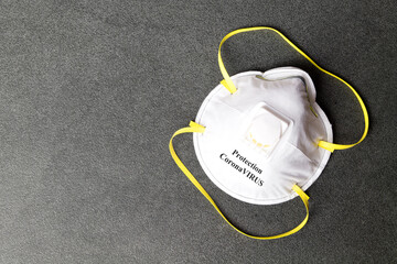 Protection mask from Coronavirus.  COVID-19 protective mask on a stone background. Personal protection equipment against viruses awareness