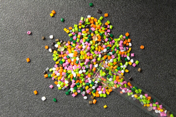 Plastic pellets. Dyes for plastic, polypropylene, polyethylene. Plastic granules on a stone background .Plastic pellets. Plastic Raw material .HDPE. BPA FREE. Ad space
