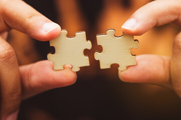 Man hand connecting jigsaw puzzle, Business solutions,Team work, success and strategy concept.