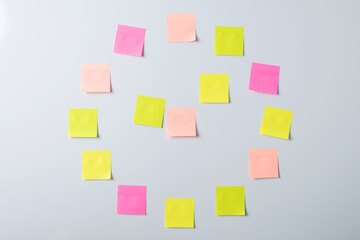 Concept of time, deadline, project or business. Sticky notes on a whiteboard in an office in a shape of a clock, differnt tasks in different time