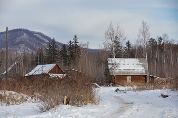 Russian village. Russian wooden house in a village in a snowy winter