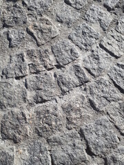 Gray paving stones laid in a semicircle on a city street. Architecture, urban design.
