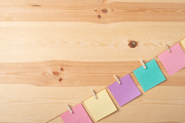 Colored notes hanging from a rope with a clopy space for inscription