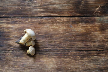 Chanterelle mushrooms on a wooden table.