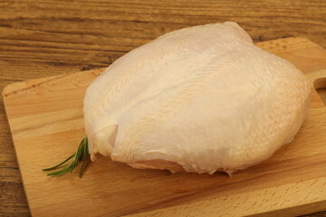 Raw whole chicken breast with skin