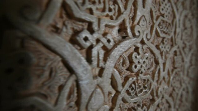Close up dolly shot of ancient arabic writing carving at the Alhambra