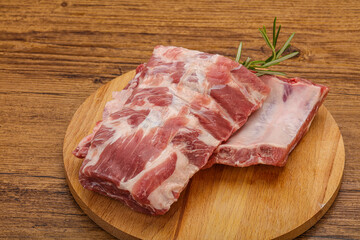Raw pork ribs served rosemary