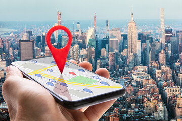 Human Hand Holding Cellphone With Navigation Sign