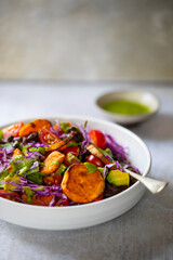 Vegan bowl with black beans, roast sweet potatoes, red cabbage and avocado