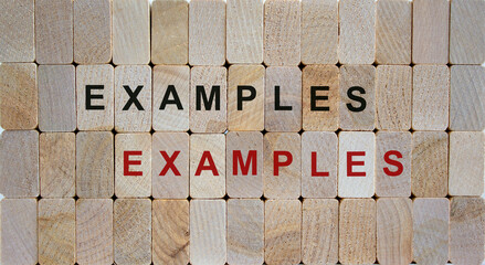 Wooden blocks form the words 'examples, examples'. Beautiful wooden background.