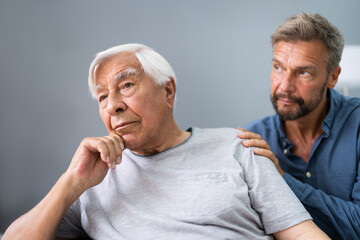 Old Senior Man With Dementia Getting Support And Care