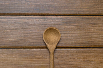 Wooden spoon on wood background. Natural kitchen tools wood product. Zero waste concept.