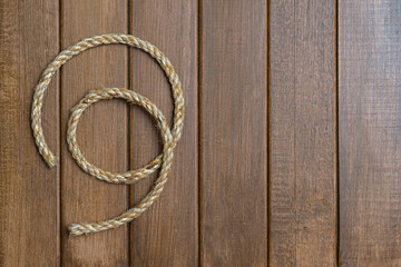 Natural hemp rope on wooden background. Natural product concept.