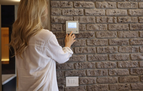 Woman using smart wall home control system