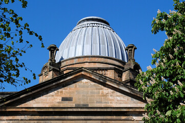 Fototapeta na wymiar View of Lead Dome on Old Stone Classical Victorian Public Building seen against Blue Sky