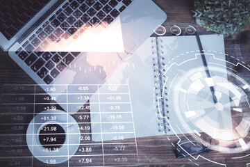 Financial market graph and top view computer on the desktop background. Double exposure. Investment concept.