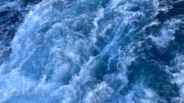 Seawater Ocean surface, sea foam on the blue ocean, background. © Ranimiro