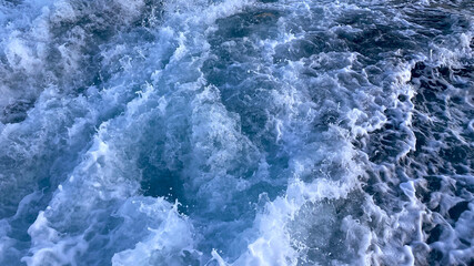 Fototapeta na wymiar Seawater surface. White foam waves texture as a natural background.