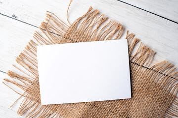 Mock-up for branding identity. Photo of blank white card. Blank card for portfolio and project presentation. Vintage burlap