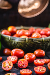 small red tomato used as a culinary ingredient in rustic cuisine, sliced ​​and diced tomatoes