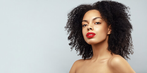 African American young woman portrait. Dark skin model with curly hair and red lips  fashion portrait.