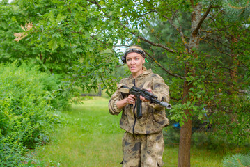 Girl playing in lasertag shooting game, girl with a gun, war simulation.