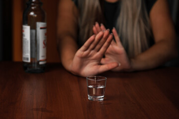 Young woman alcoholic social problems concept sitting refusal of alcohol