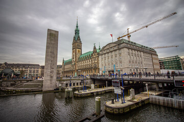 Lake Binnenalster in Altstadt quarter and  at the background the famous Hamburg town hall with dramatic clouds at market square Hamburg, Germany.