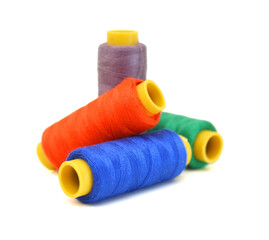 Spool of coloured thread isolated on white background. 
