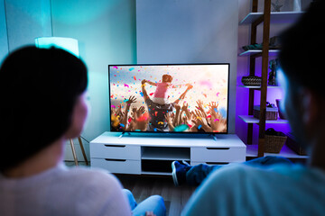 Family Couple Watching TV Or Movie - Powered by Adobe